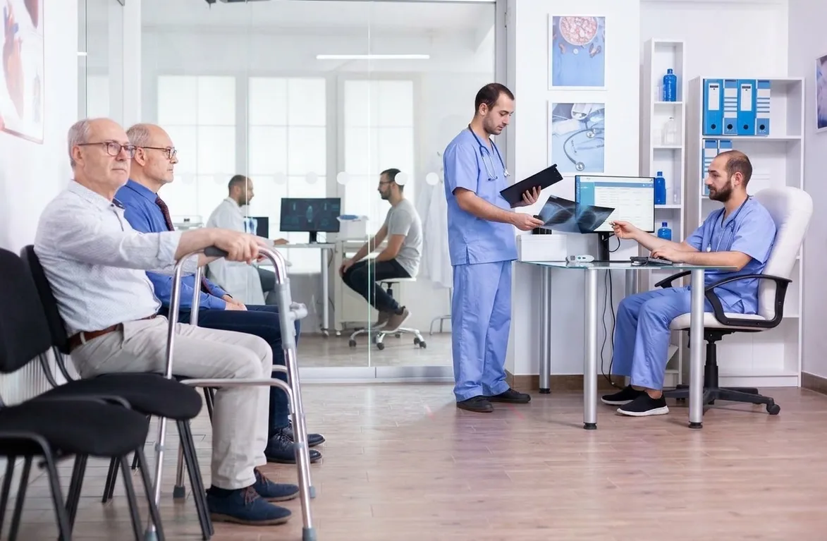 Hospital reception area with staff and patients