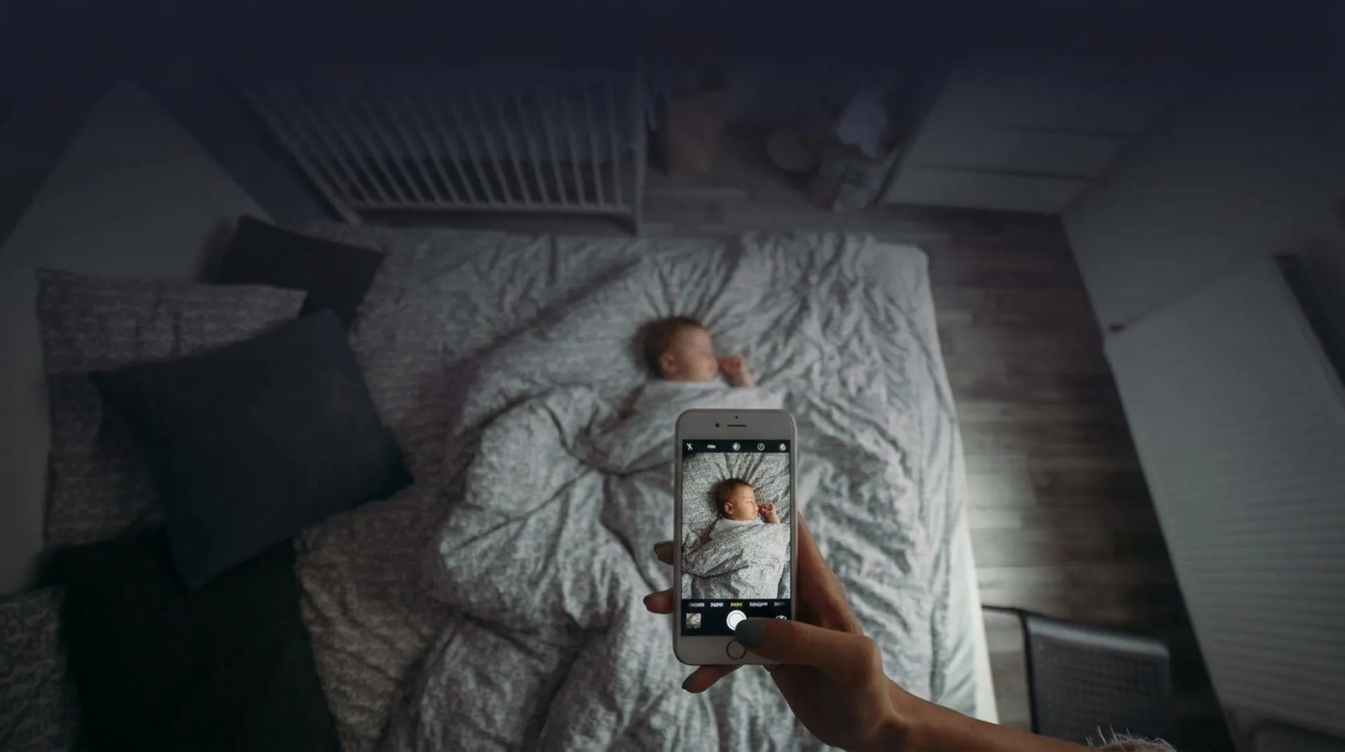 Family checking an indoor camera feed on a phone at night